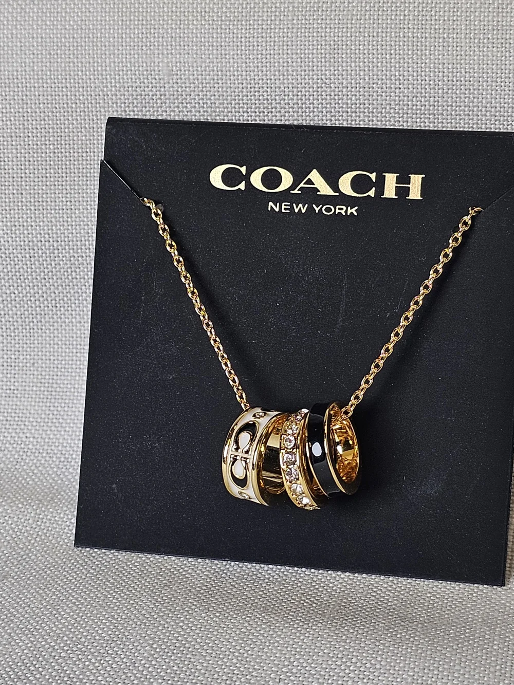 COACH Gold and Black Pendant Necklace with Crystal Accents